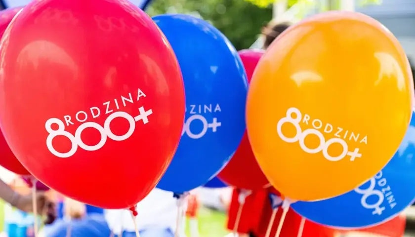 Kolorowe balony z napisem "RODZINA 800+". Radosna atmosfera wsparcia dla rodzin.